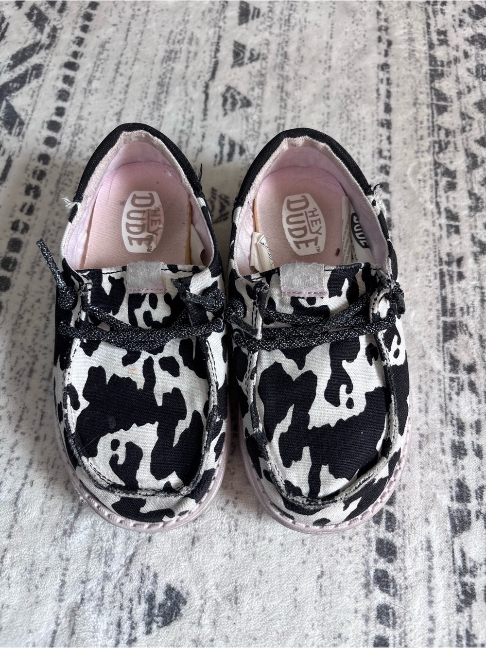 Hey Dude Kids Black & White Cow Print Slip-Ons with Pink Lining